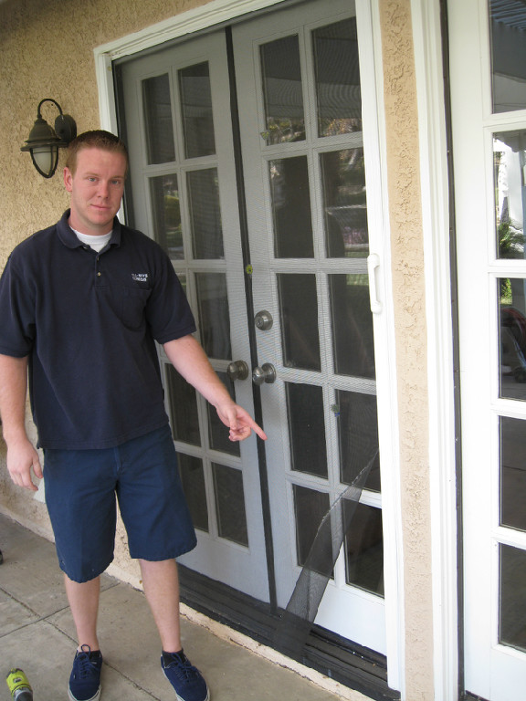 ALL-WAYS SCREENS technician showing a retractable double-door screen
